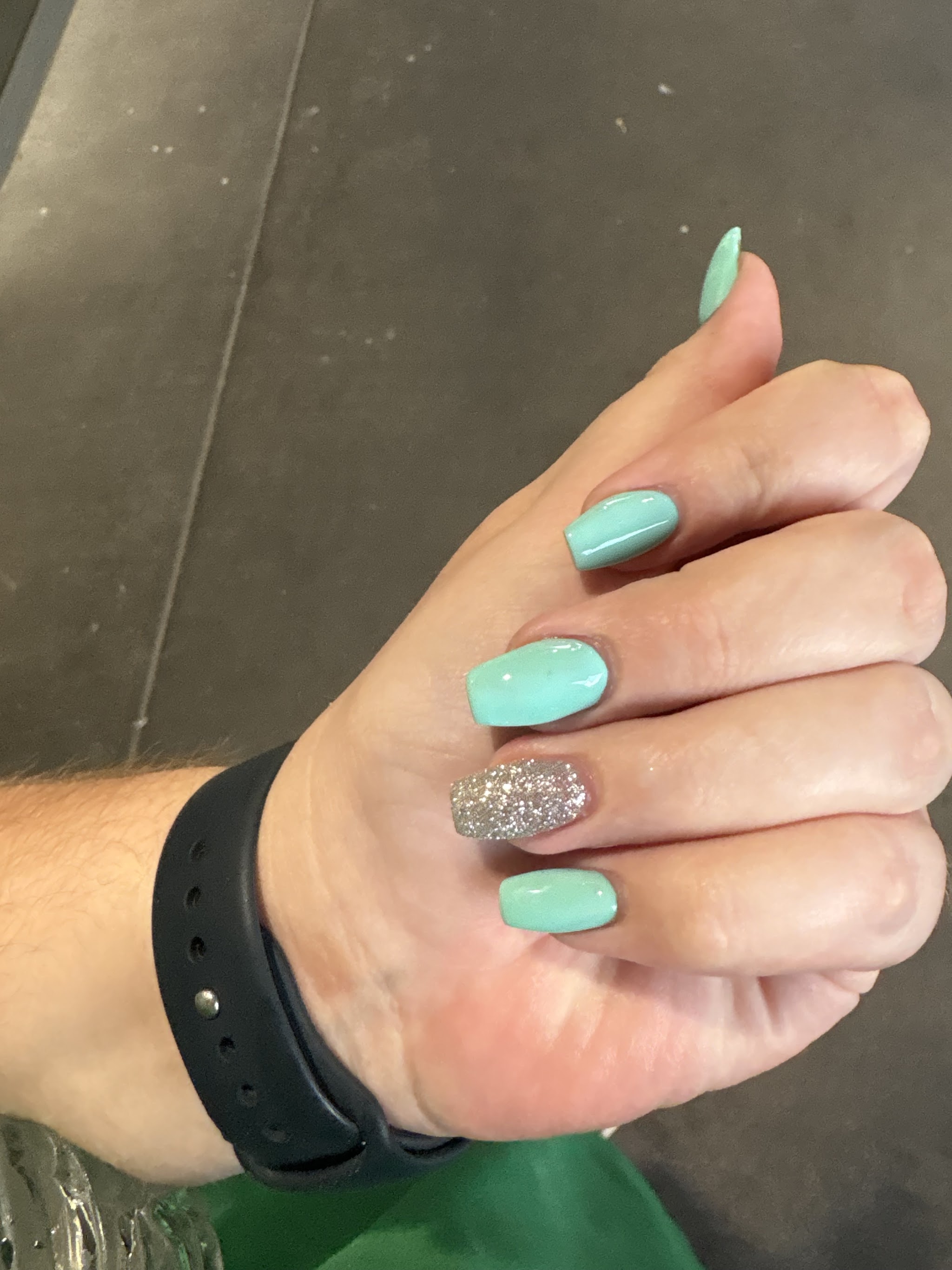 Mint green gel nails with a silver glitter accent nail